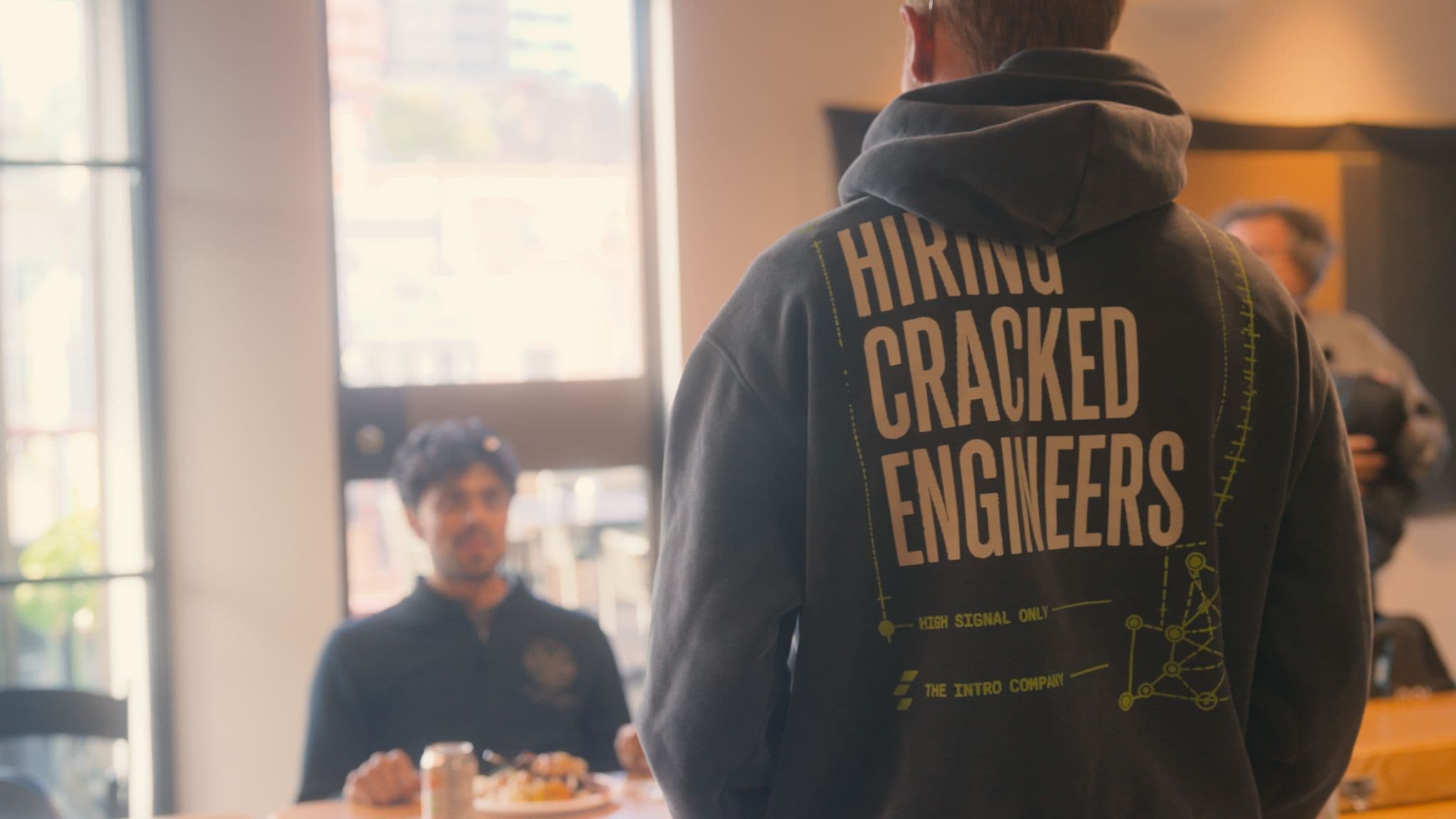 Someone wearing the Clera hoodie, back print facing the camera